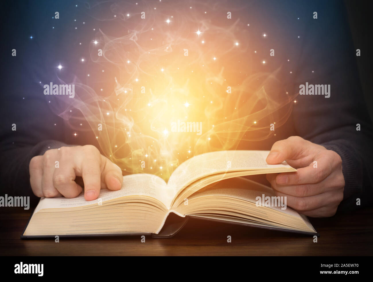 open magic book with shining light sparkles Stock Photo