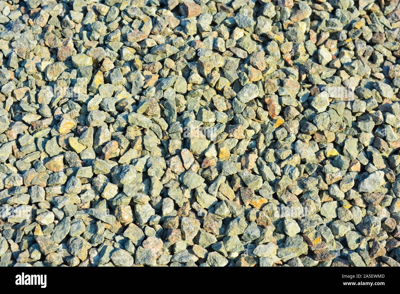 Building materials for construction and repair work, clean fine gravel rubble, a pile of building pebbles in the autumn sunlight. Stock Photo