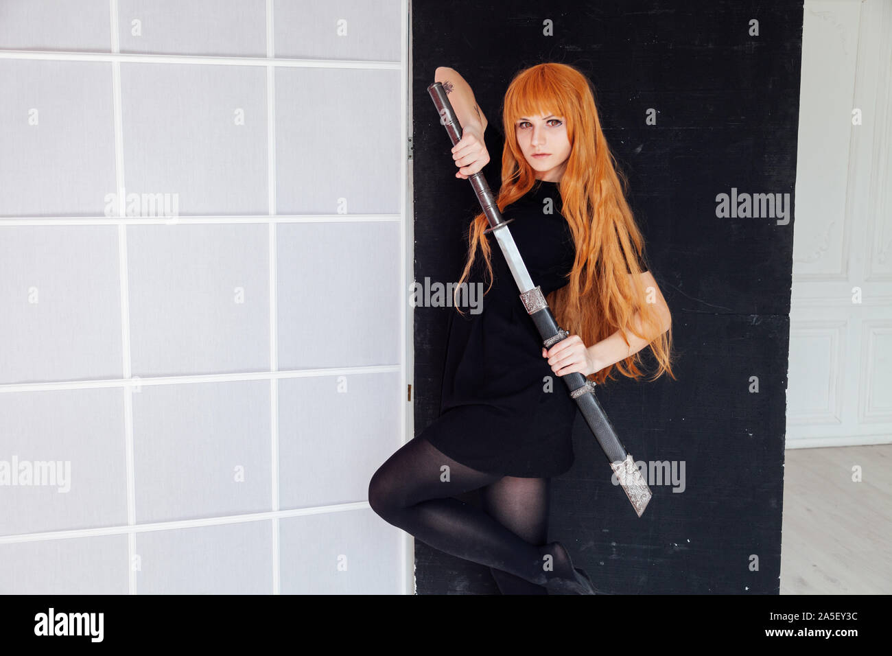Girl cosplayer with red hair anime Japan Stock Photo