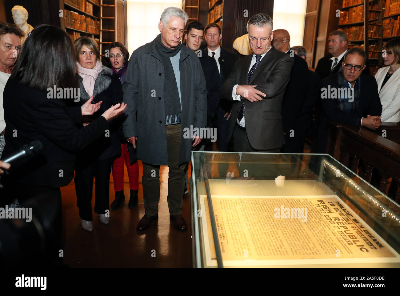 Cuban president Miguel Diaz-Canel (centre left) is shown one of a dozen or so surviving original prints of the Proclomation of 1916 by Provost of Trinity College Patrick Prendergast in the Long Hall, Dublin, on the first day of a three day visit to Ireland. Stock Photo