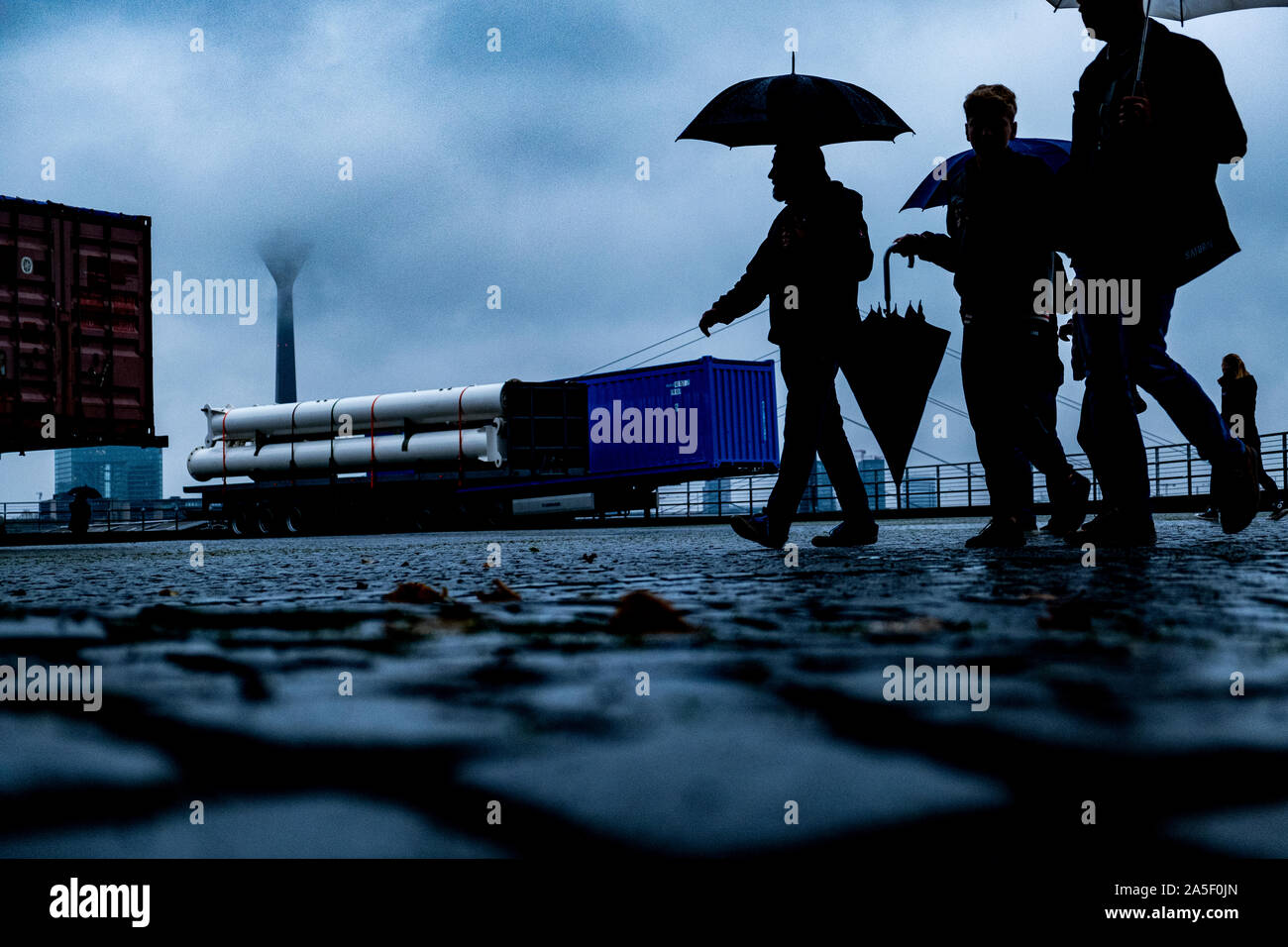 People walking in Düsseldorf near the rhine river at a rainy day in autumn. Stock Photo