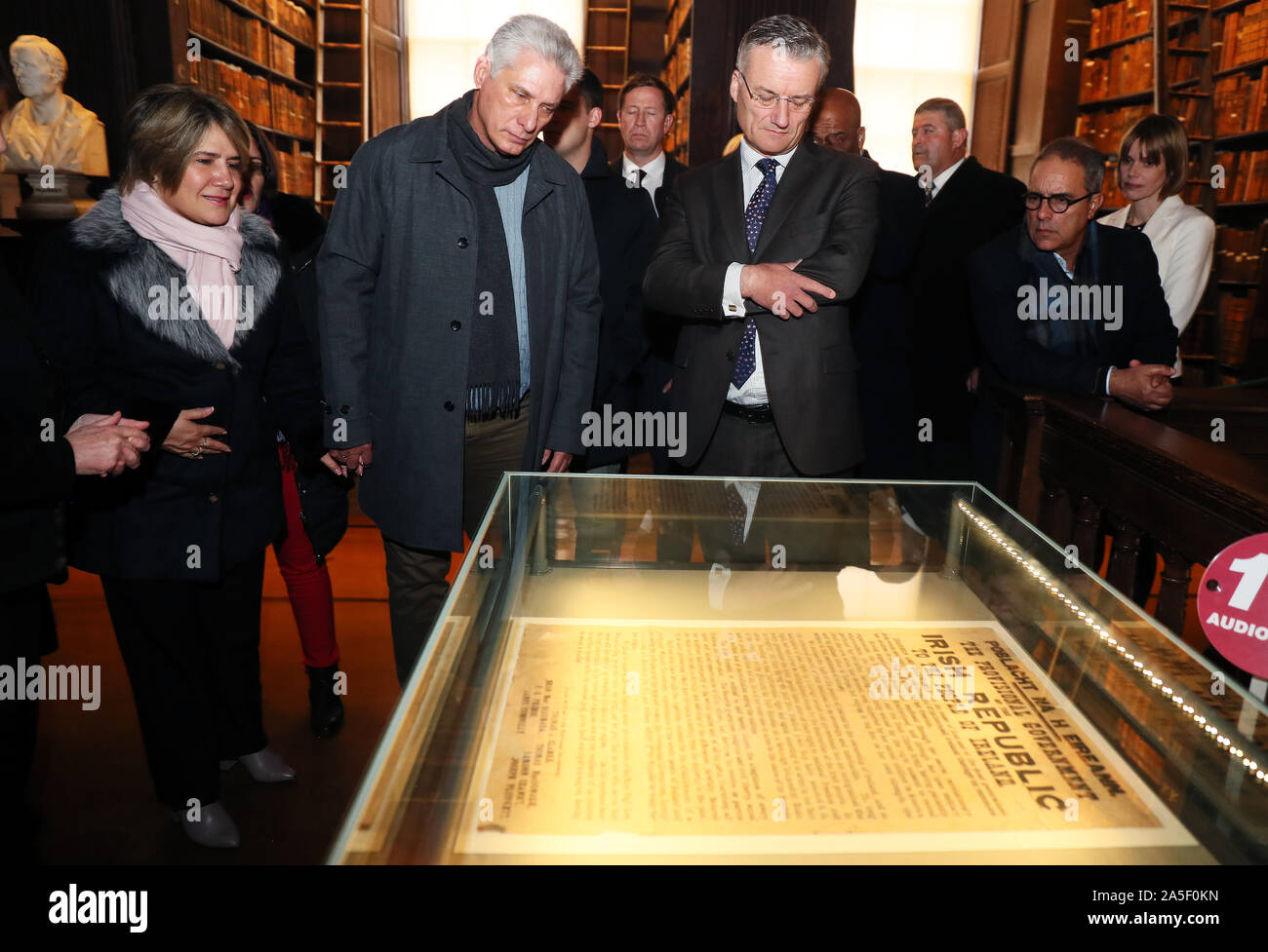 Cuban president Miguel Diaz-Canel (centre left) and his wife Lis Cuesta Peraza (left) are shown one of a dozen or so surviving original prints of the Proclomation of 1916 by Provost of Trinity College Patrick Prendergast (centre right) in the Long Hall, Dublin, on the first day of a three day visit to Ireland. Stock Photo