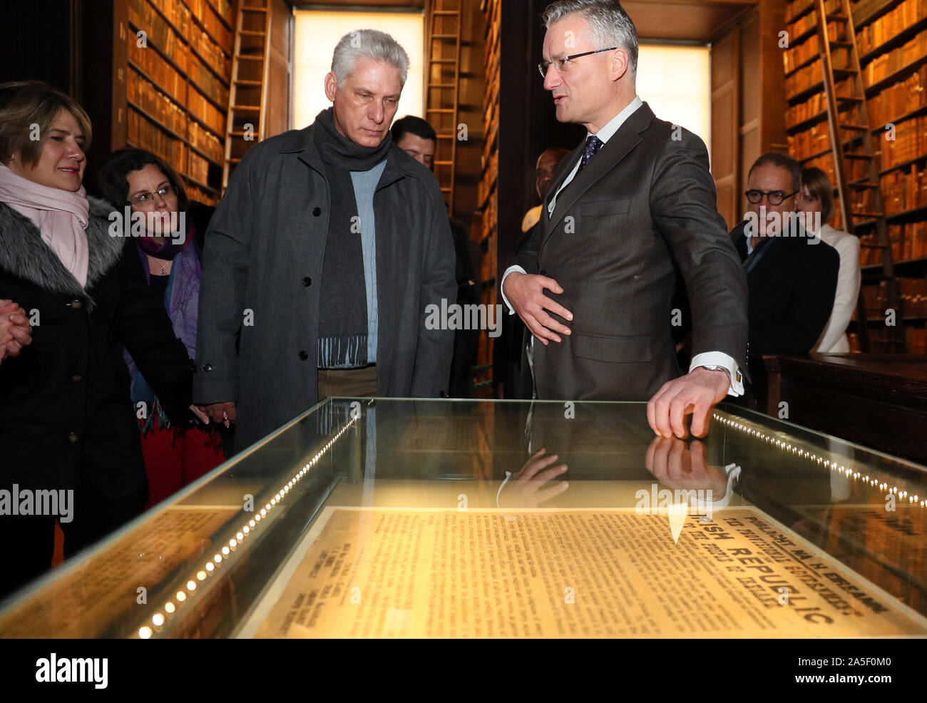 Cuban president Miguel Diaz-Canel (centre left) and his wife Lis Cuesta Peraza (left) are shown one of a dozen or so surviving original prints of the Proclomation of 1916 by Provost of Trinity College Patrick Prendergast (centre right) in the Long Hall, Dublin, on the first day of a three day visit to Ireland. Stock Photo