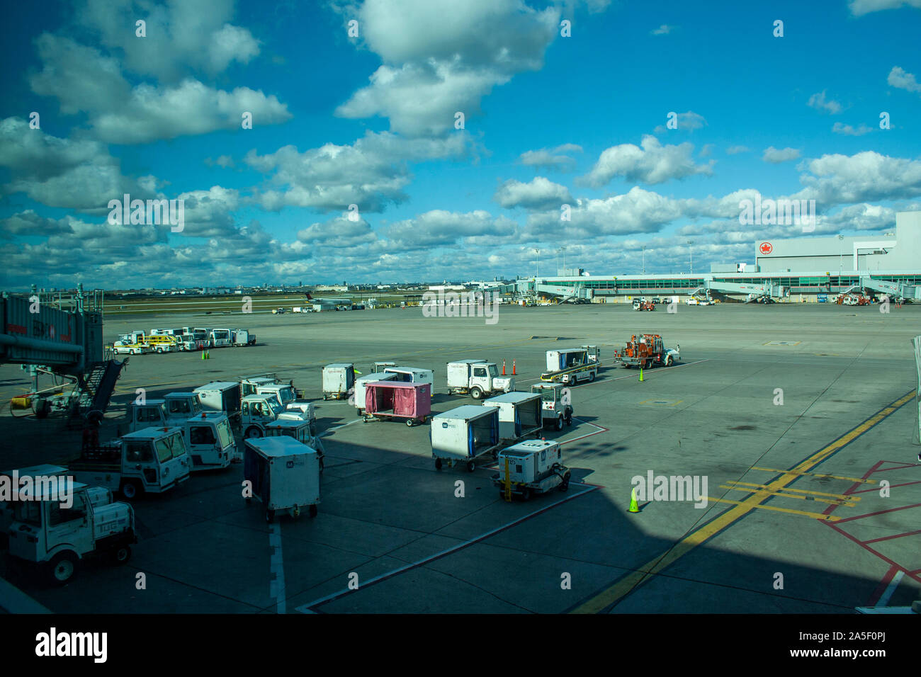 October 14, 2019 - Toronto, Ontario Canada- Empty luggage carriers on the gate tarmac at Pearson Airport in Toronto Stock Photo