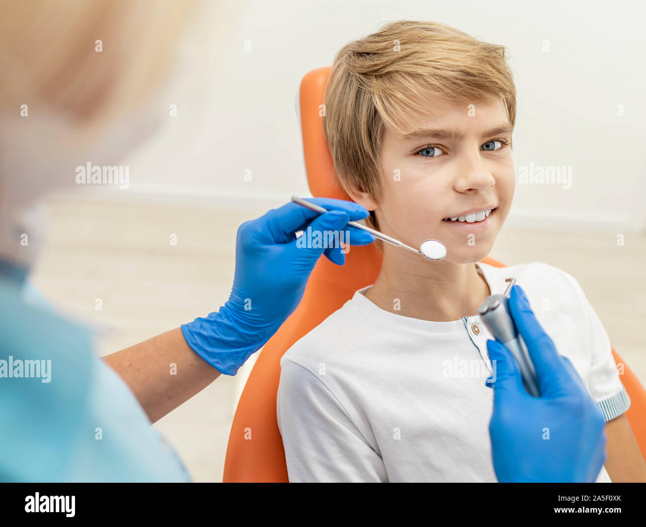 Inspired blond boy is ready for his teeth to be examined by dentist Stock Photo