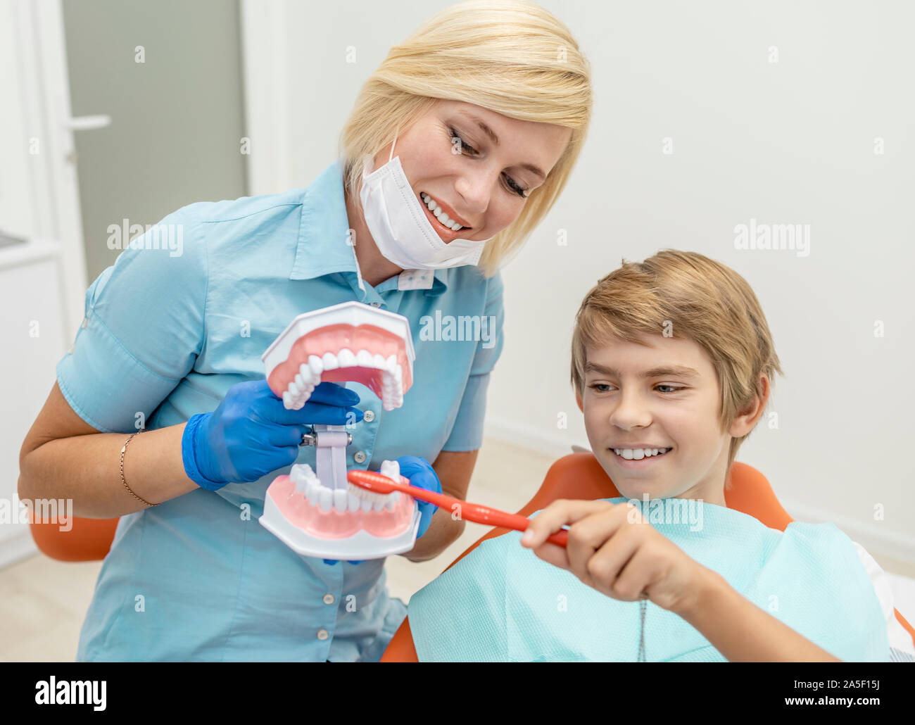 Boy having a fun tutorial about proper teeth care and hygiene at the dentist's Stock Photo