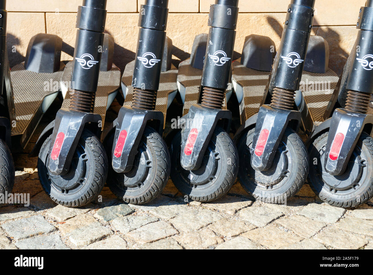 WROCLAW, POLAND - OCTOBER 6, 2019: Frontal view of five used model Bird Zero electric scooter (E-Scooters) frames from Bird parked near a wall. Stock Photo