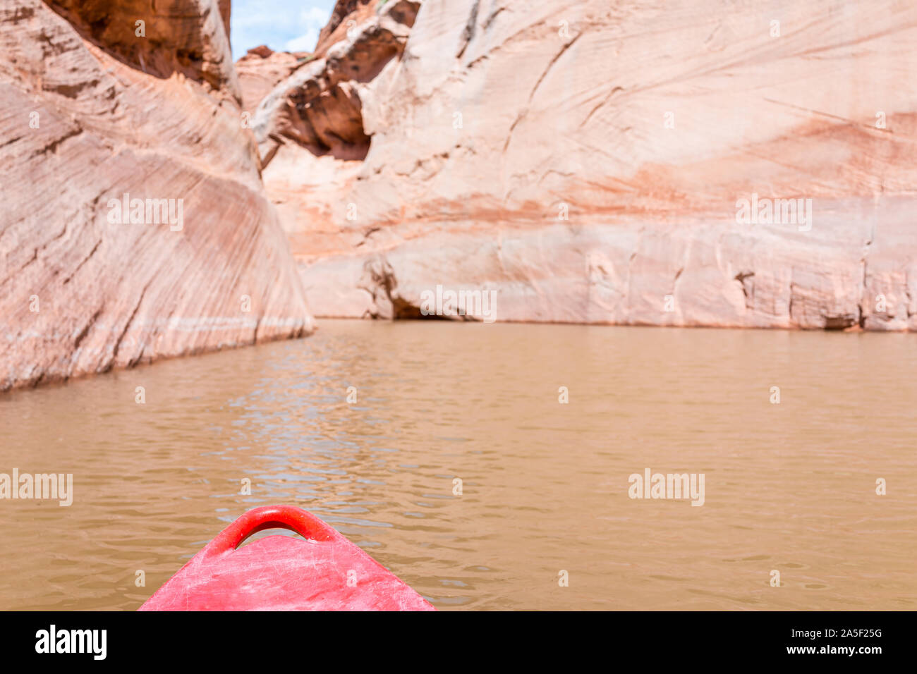 Kayaking in Lake Powell narrow antelope canyon with front of red kayak