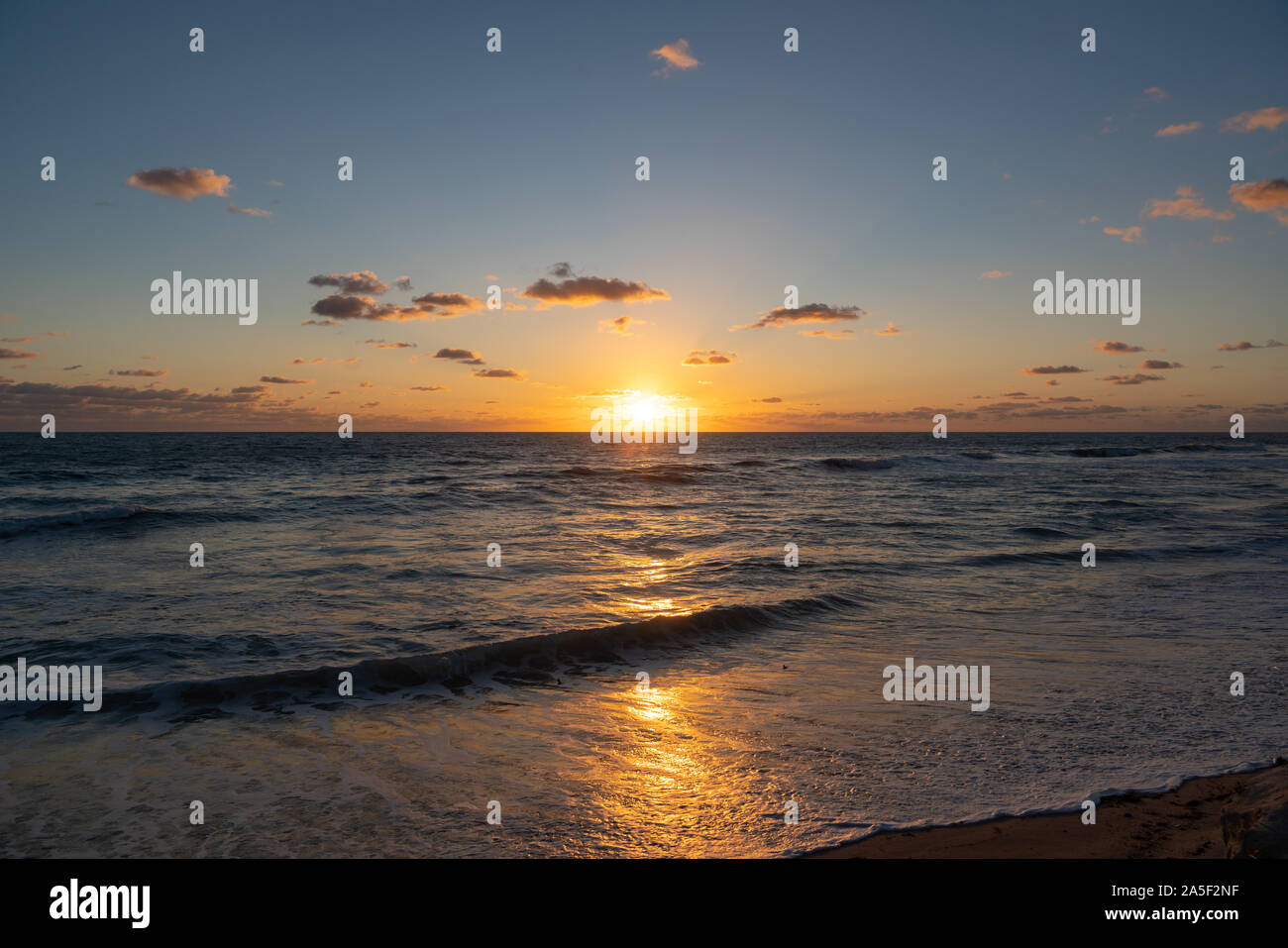 The almost clear sky gives a perfect view of the sunrise in Florida Stock Photo