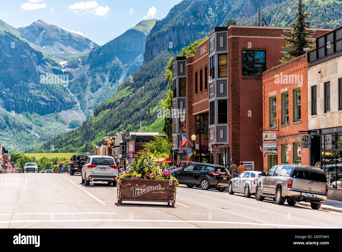 Telluride, USA - August 14, 2019: Vacation town village in Colorado with sign for city and flowers by historic architecture on main street mountain vi Stock Photo