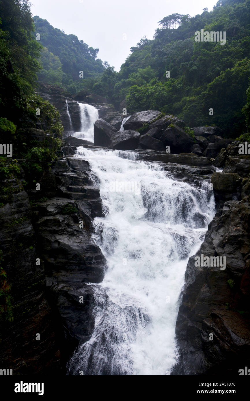 Close up of waterfall in Shillong in motion blur and rocks, selective