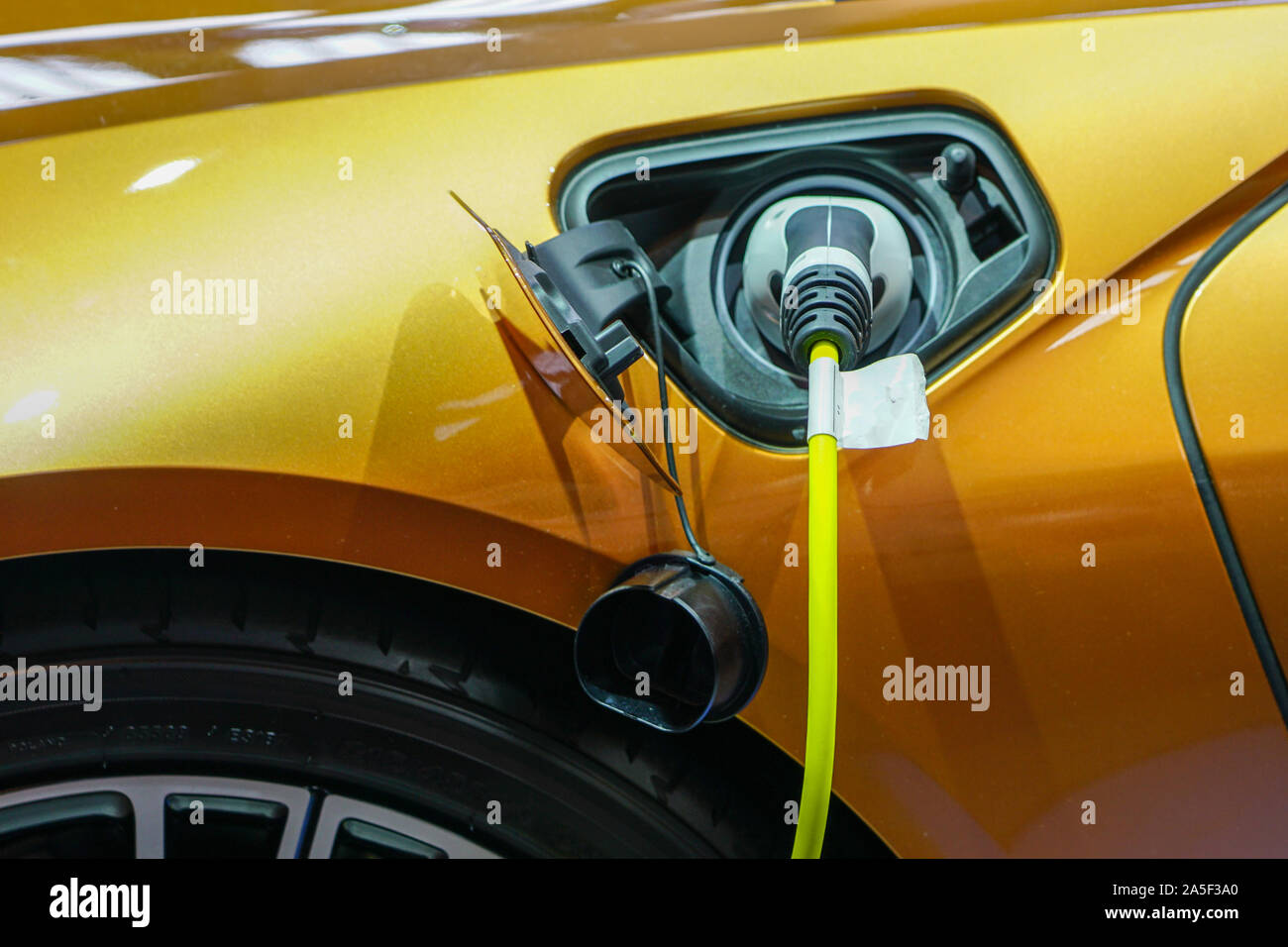 The electric car charger plugged in to the socket Stock Photo Alamy
