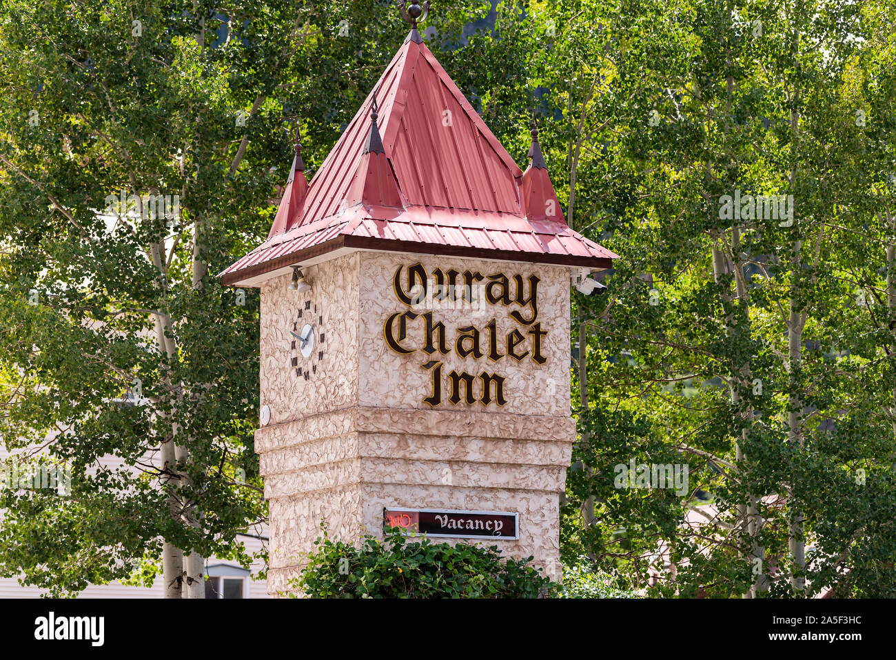 Ouray, USA - August 14, 2019: Small town in Colorado with city main street and closeup of chalet inn hotel sign historic architecture clock tower Stock Photo