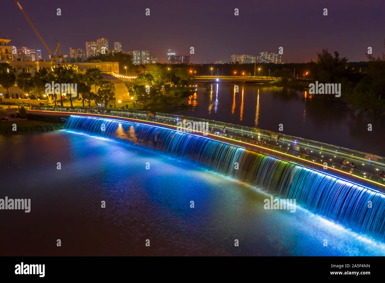 Anh Sao or Starlight Bridge is a pedestrian bridge with  waterfall and beautiful colored lighting on the Saigon River. It is a tourist attraction Stock Photo