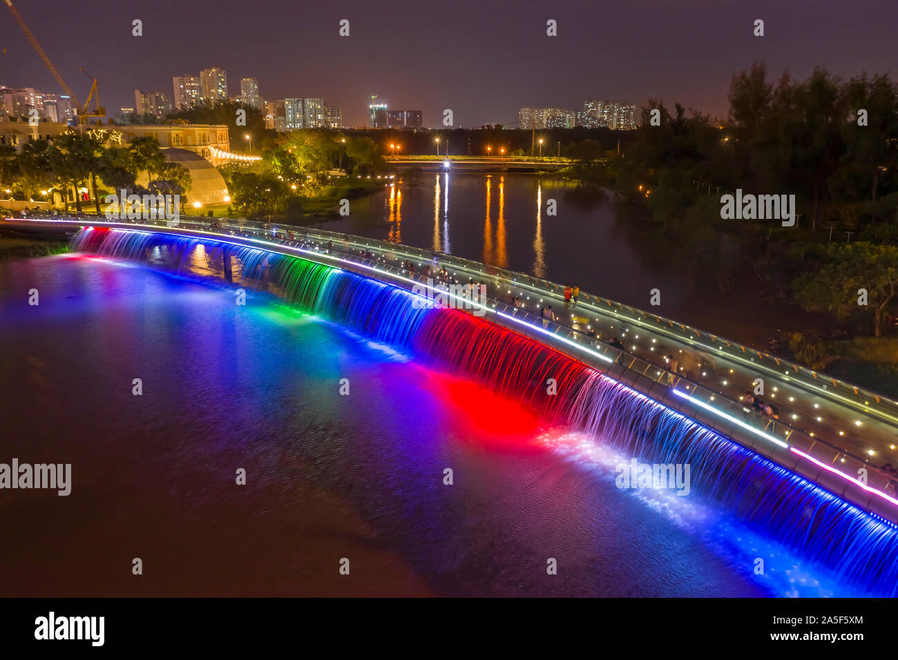 Anh Sao or Starlight Bridge is a pedestrian bridge with  waterfall and beautiful colored lighting on the Saigon River. It is a tourist attraction Stock Photo