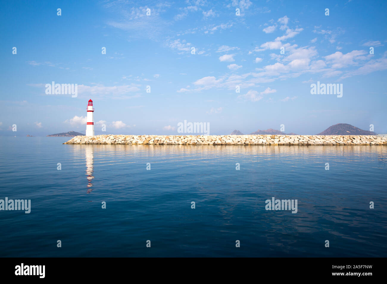 Lighthouse, reflected on water. Mediterranean sea Stock Photo Alamy