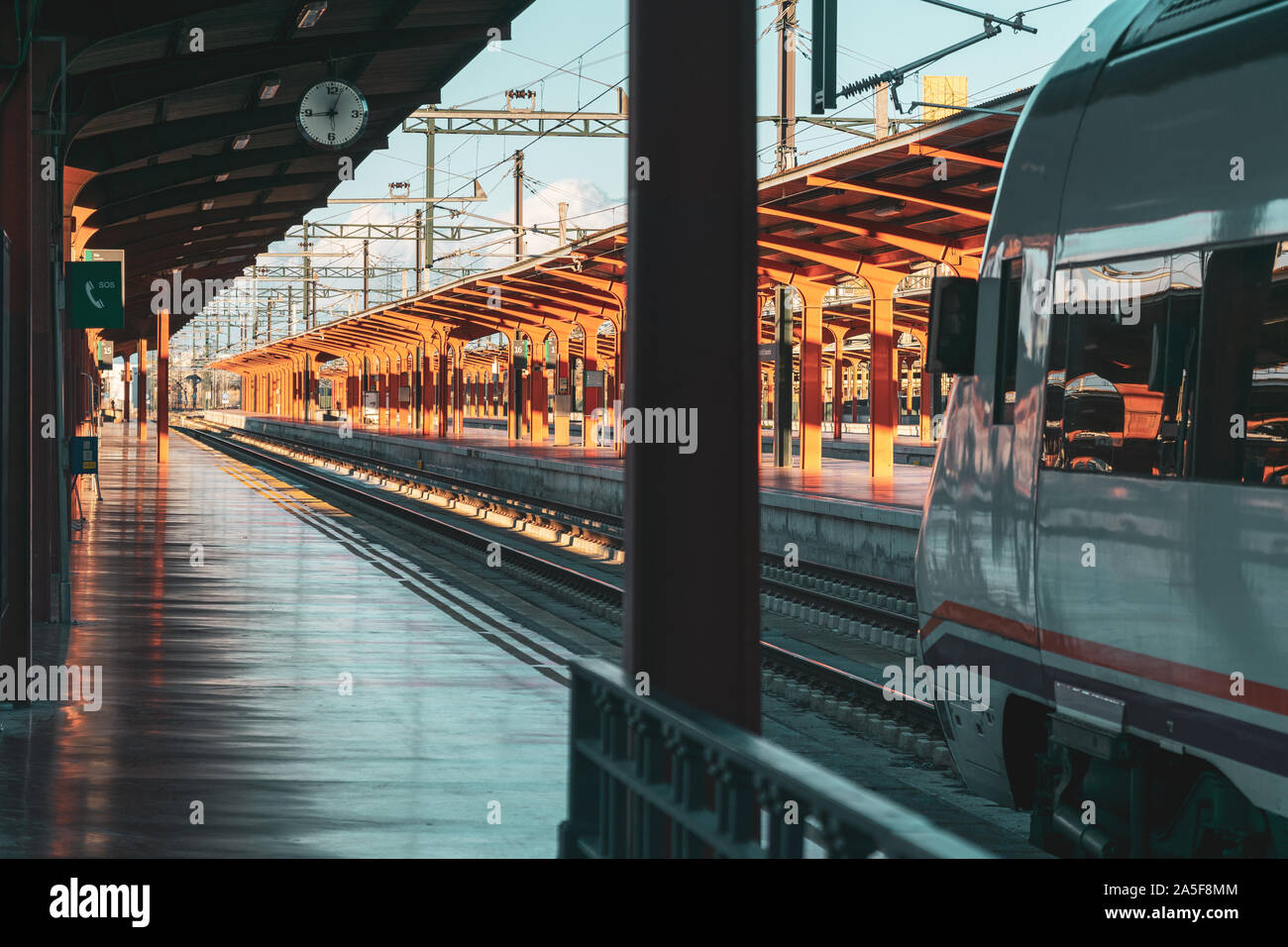 Travel by train concept. Empty station with train ready to leave. Sunset Autumn Light. Madrid, Spain. Stock Photo