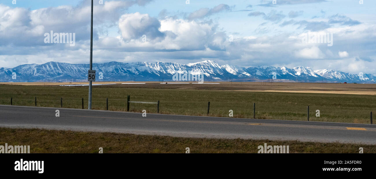 Southern Alberta prairie and mountain view with highway. Stock Photo