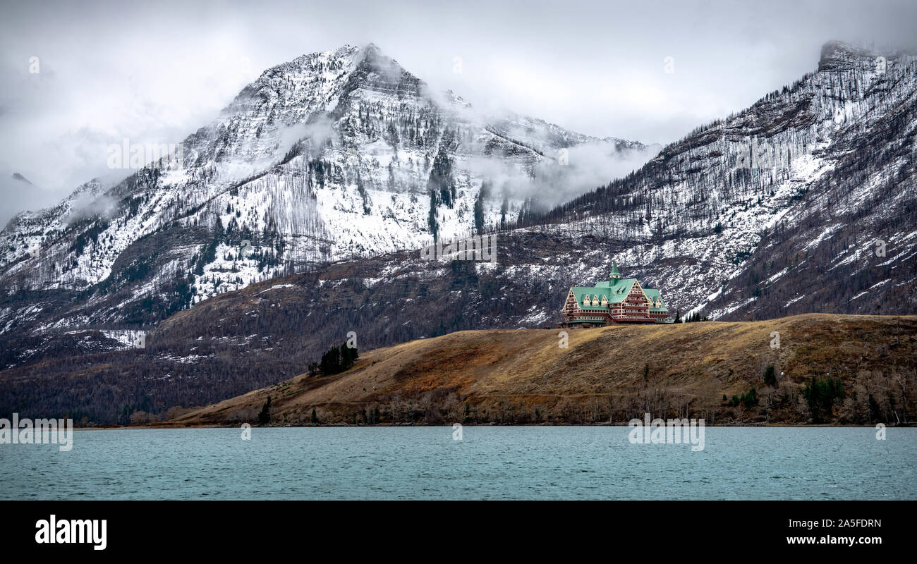 Historic Canadian hotel with snowy rocky mountains as a background. Stock Photo