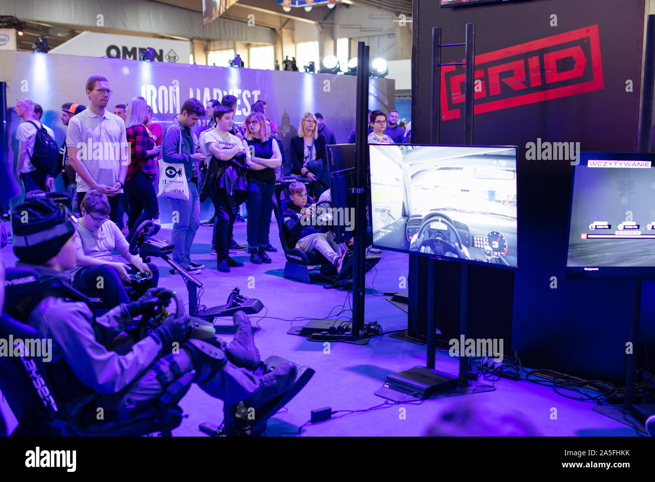 POZNAN, POLAND - October, 19th 2019: People playing the GRID game at the PGA2019. PGA2019 is a computer games and entertainment event organized in pol Stock Photo
