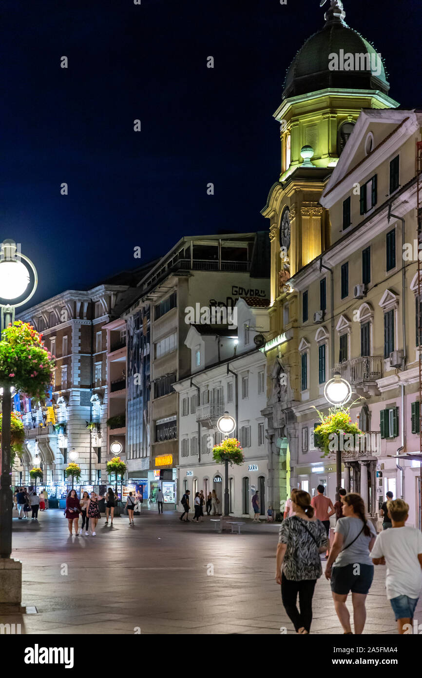 The Korzo pedestrian shopping zone and city clock tower in  the evening. Rijeka city centre, Croatia, 2019 Stock Photo