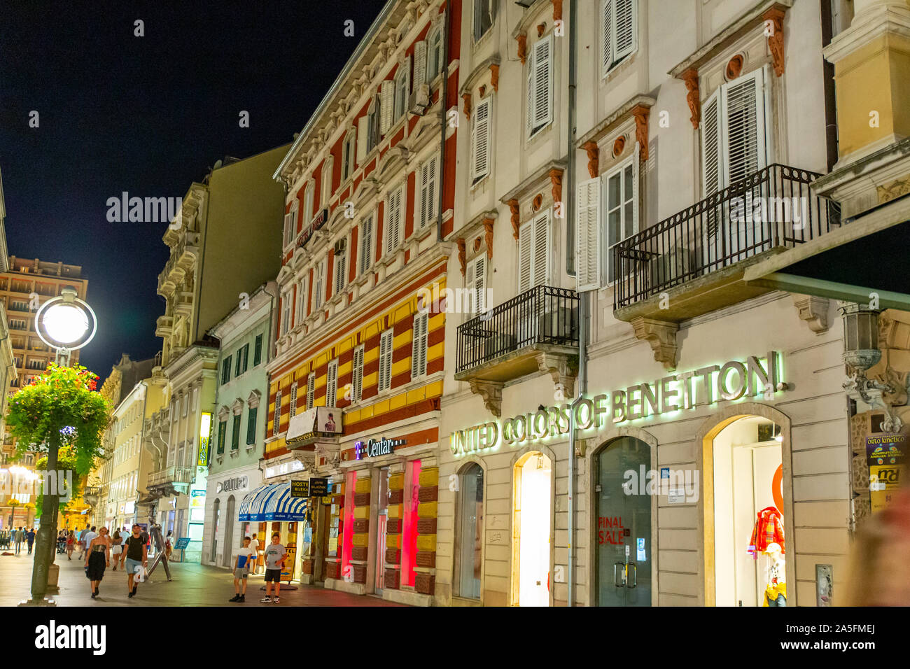 Colourful modern shops occupy the lower floors of the colourful buildings on the Korzo (Rijeka's pedestrian shopping zone). Stock Photo