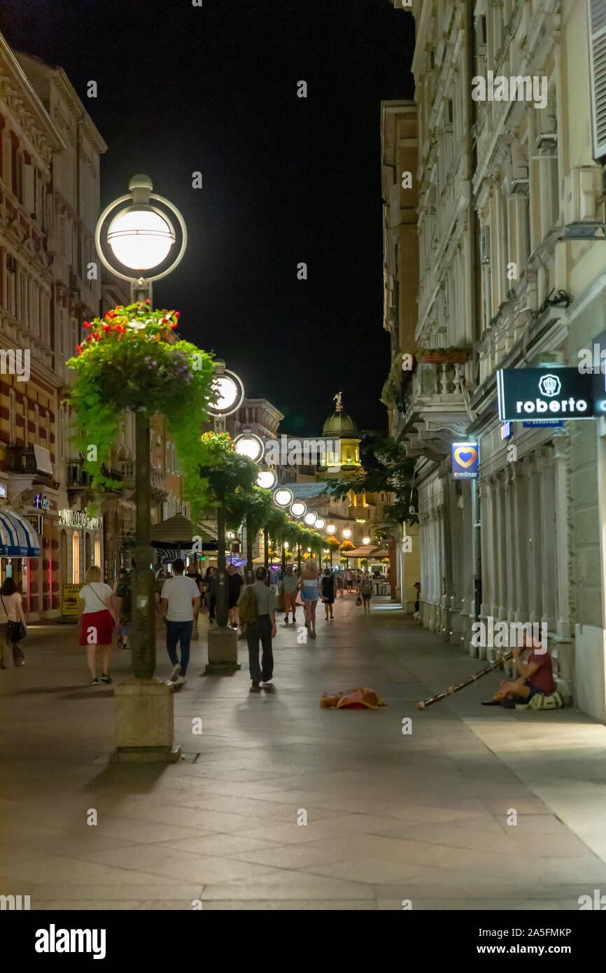 The Korzo shopping street on a summer evening wit a street busker playing a didgeridoo.  Rijeka, Croatia Stock Photo