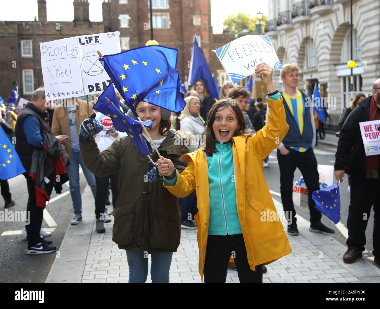 London, UK. 19th Oct 2019. Two girls supporting the EU as hundreds of thousands of people demonstrate en route to Parliament in a 'People's Vote - Final Say' march. The House of Commons is sitting, for the first time in 37 yards, on a Saturday to discuss the new Brexit deal. People's vote march, London, UK on October 19, 2019. Credit: Paul Marriott/Alamy Live News Stock Photo
