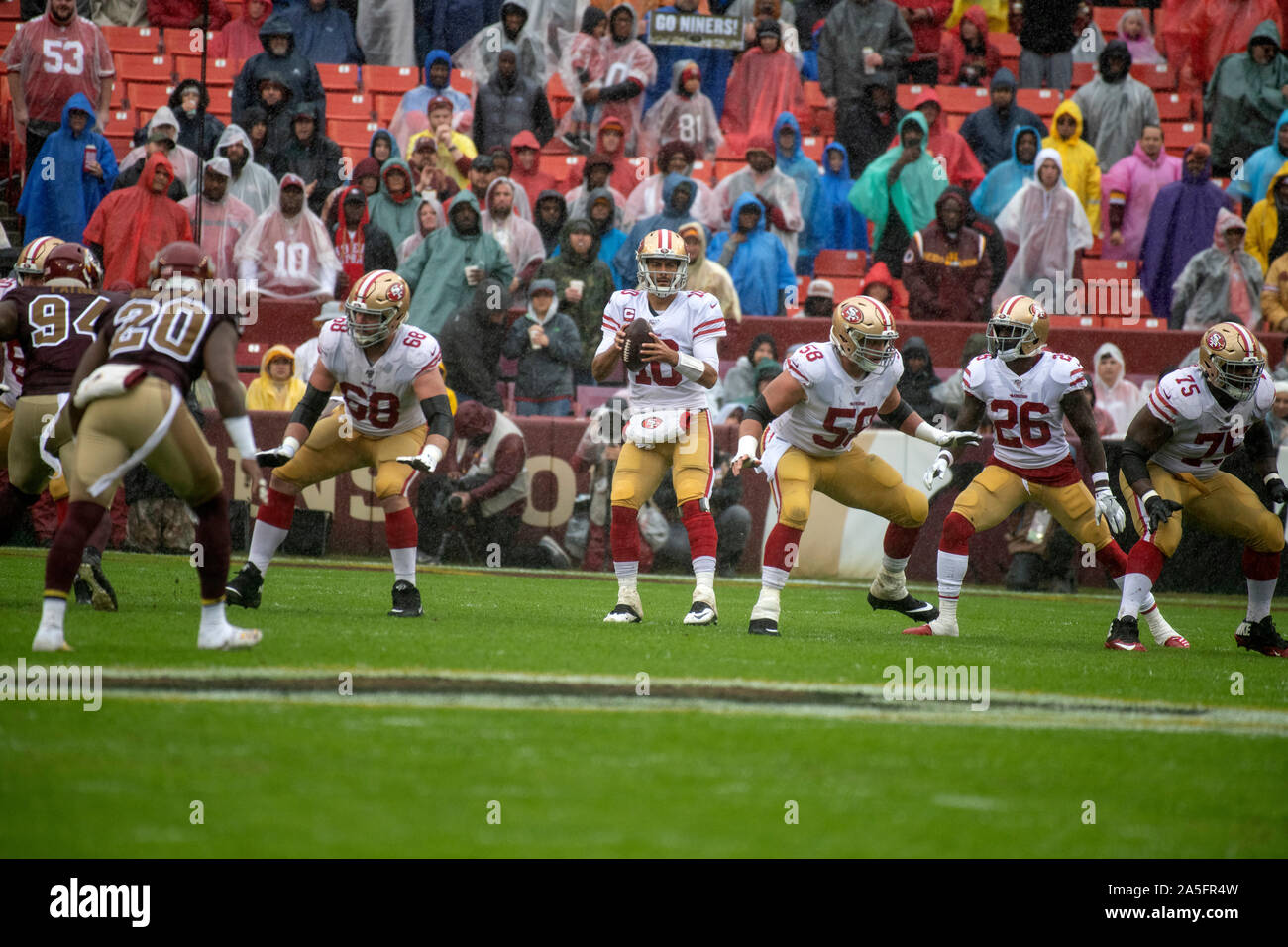 San Francisco 49ers quarterback Jimmy Garoppolo (10) looks for a receiver during the first quarter against the San Francisco 49ers at FedEx Field in Landover, Maryland on Sunday, October 20, 2018. Also pictured from left are: Washington Redskins nose tackle Daron Payne (94), strong safety Landon Collins (20), San Francisco 49ers offensive guard Mike Person (68), center Weston Richburg (58), running back Tevin Coleman (26) and offensive guard Laken Tomlinson (75). The 49ers won the game 9 - 0.Credit: Ron Sachs/CNP | usage worldwide Stock Photo