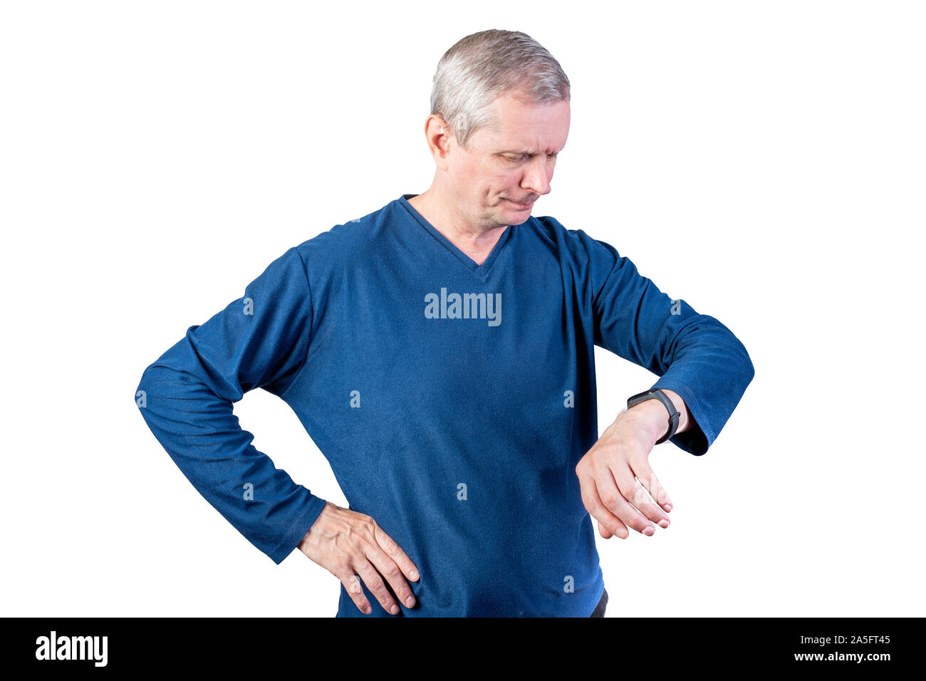 An elderly man measures the pulse of a fitness bracelet. Isolated on a white background. Stock Photo