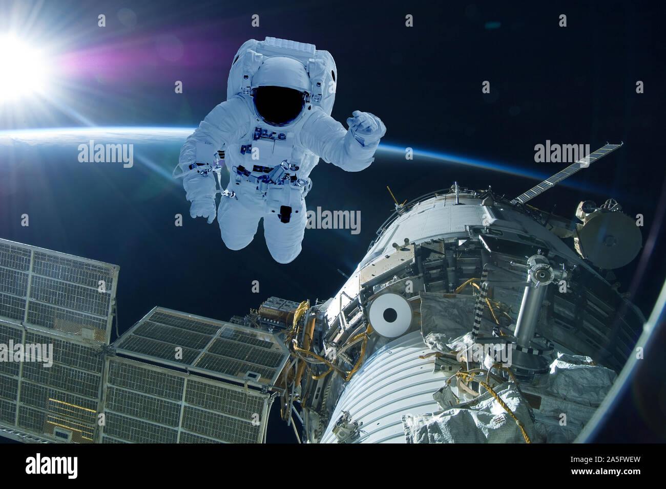 Astronaut at the space station. On the background of the earth. Elements of this image were furnished by NASA. Stock Photo