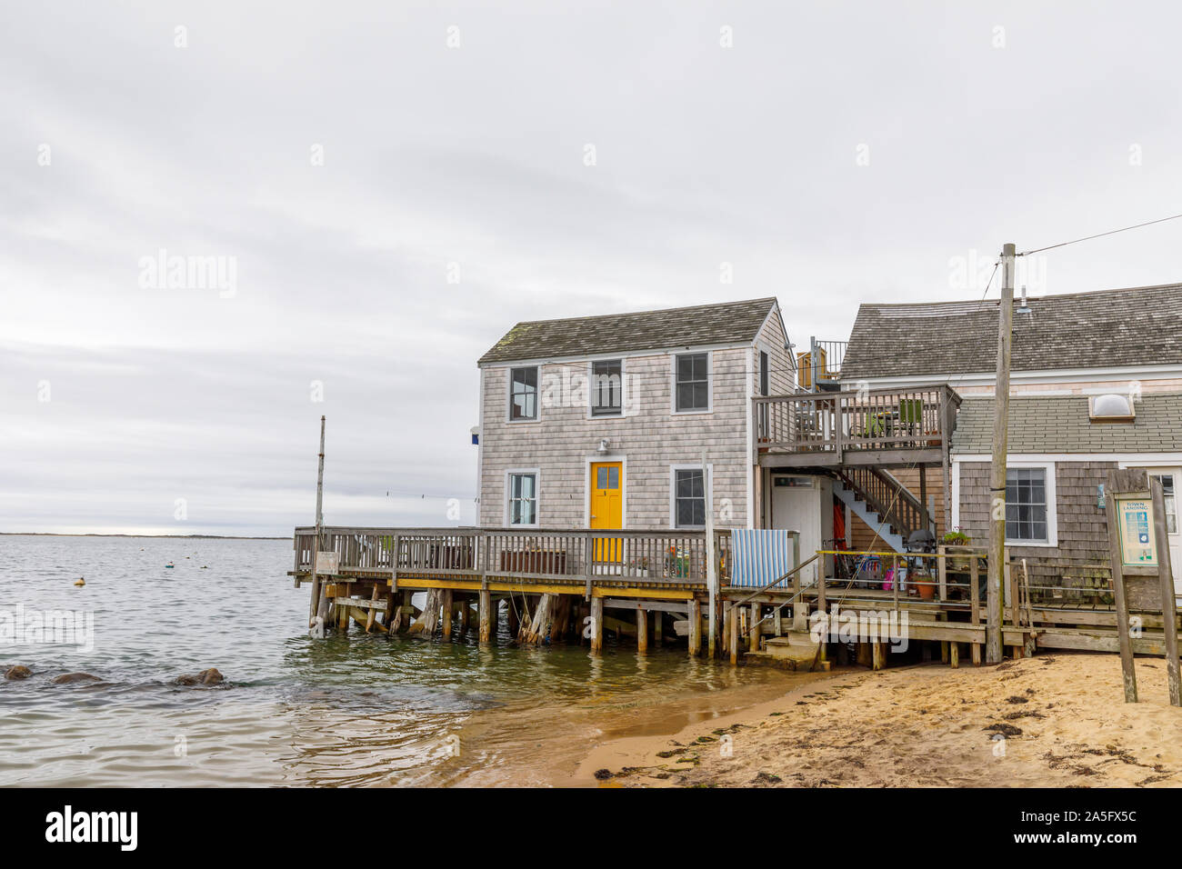 Town Landing with typical cedar shingle building on a jetty on the coast in downtown Provincetown, Cape Cod, New England, USA Stock Photo