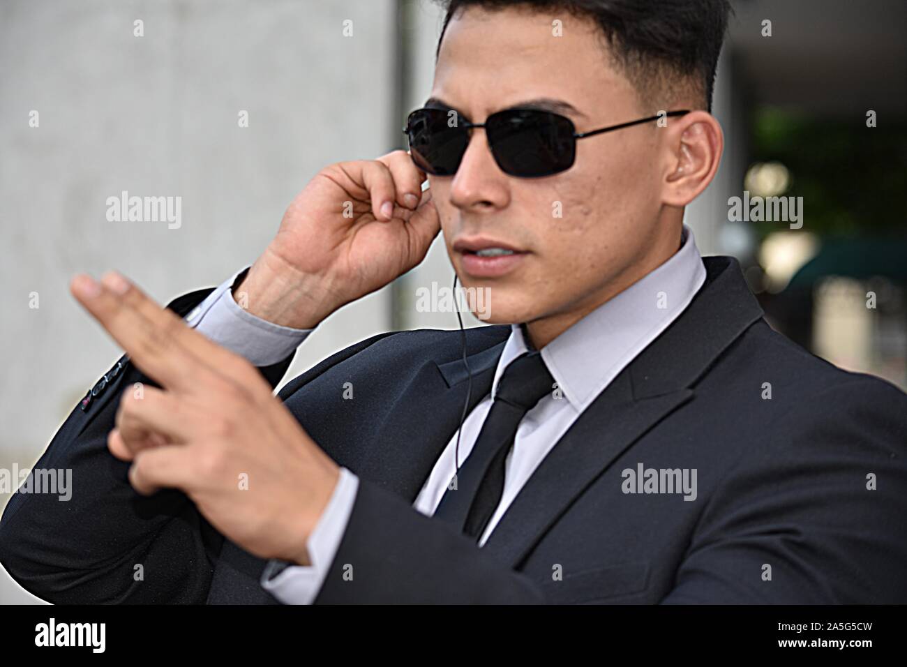 Handsome Security Guard Pointing Wearing Sunglasses Stock Photo - Alamy