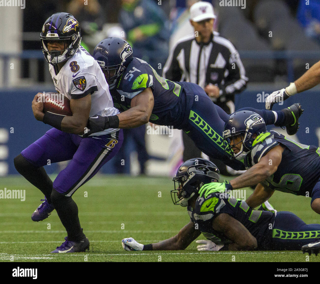 Seattle, United States. 20th Oct, 2019. Baltimore Ravens quarterback Lamar Jackson (8) breaks the attempted tackle by Seattle Seahawks middle linebacker Bobby Wagner (54) for an 8-yard gain during the fourth quarter at CenturyLink Field on Sunday, October 20, 2019 in Seattle, Washington. Jackson led the Ravens Ravens to a 30-16 victory over the Seahawks. Photo by Jim Bryant/UPI Credit: UPI/Alamy Live News Stock Photo