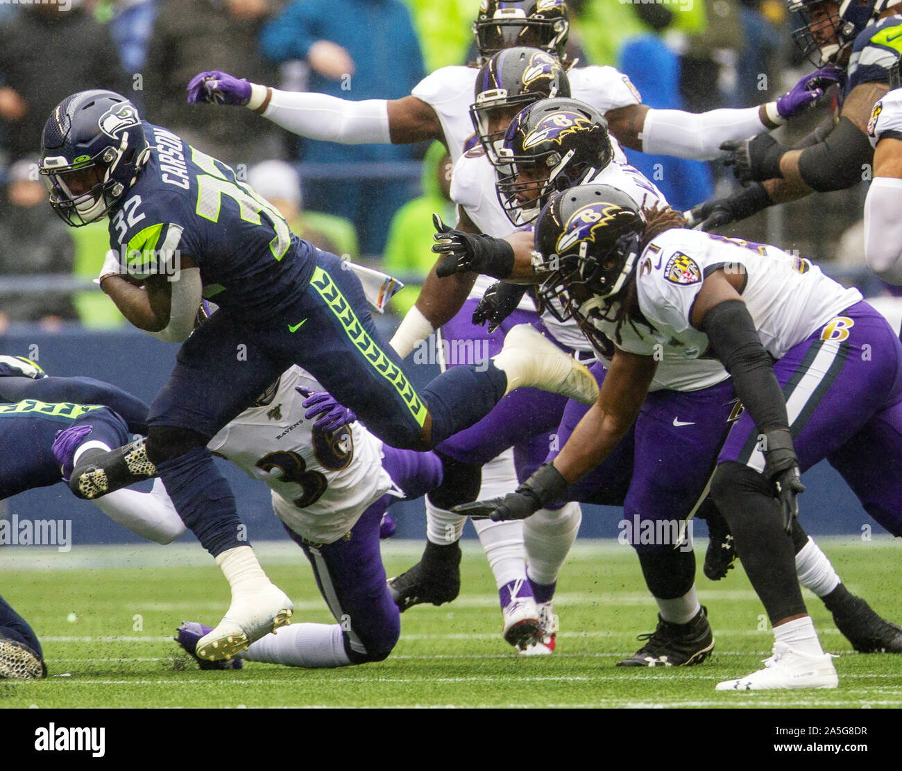 Seattle, United States. 20th Oct, 2019. Seattle Seahawks running back Chris Carson (32) breaks attempted tackles by the Baltimore Ravens at CenturyLink Field on Sunday, October 20, 2019 in Seattle, Washington. The Ravens beat the Seahawks 30-16. Photo by Jim Bryant/UPI Credit: UPI/Alamy Live News Stock Photo