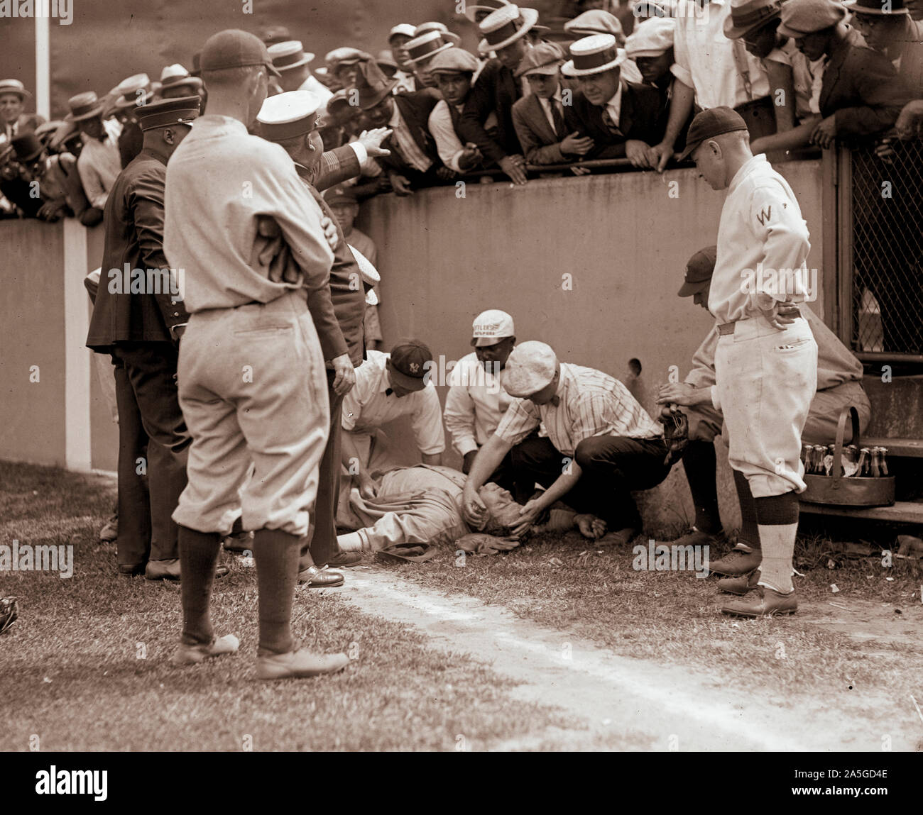 Photo shows baseball player Babe Ruth knocked unconscious, after he ran into a concrete wall at Griffith Stadium, Washington, D.C., while trying to catch a foul ball on July 5, 1924. Stock Photo