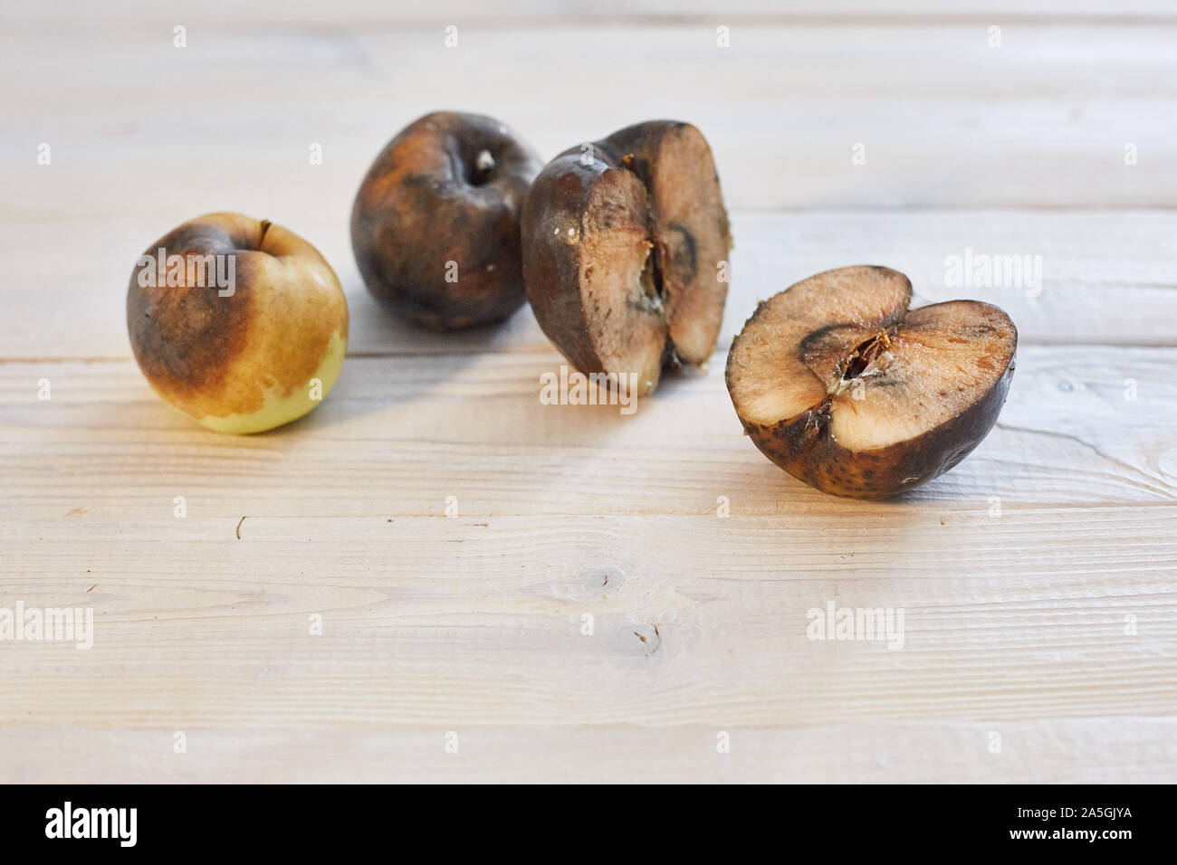 rotten sliced apple on a wooden surface Stock Photo