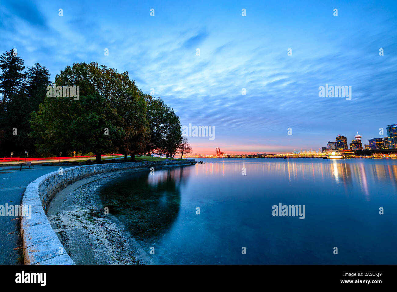 Light trail along Vancouver seawall during October sunrise Stock Photo