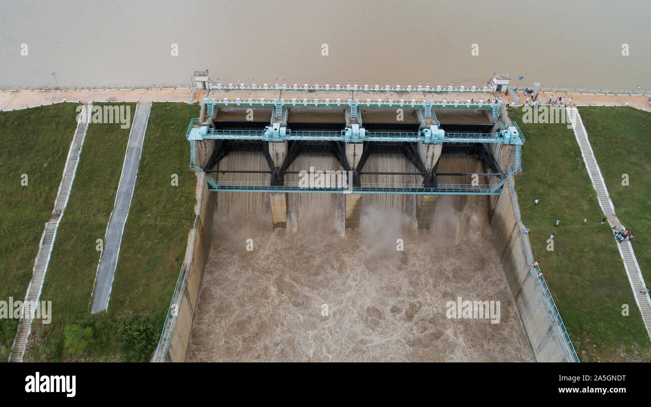 Close up Aerial bird eye of water reservoir flood gates open to release water from dam at raichur, India Stock Photo