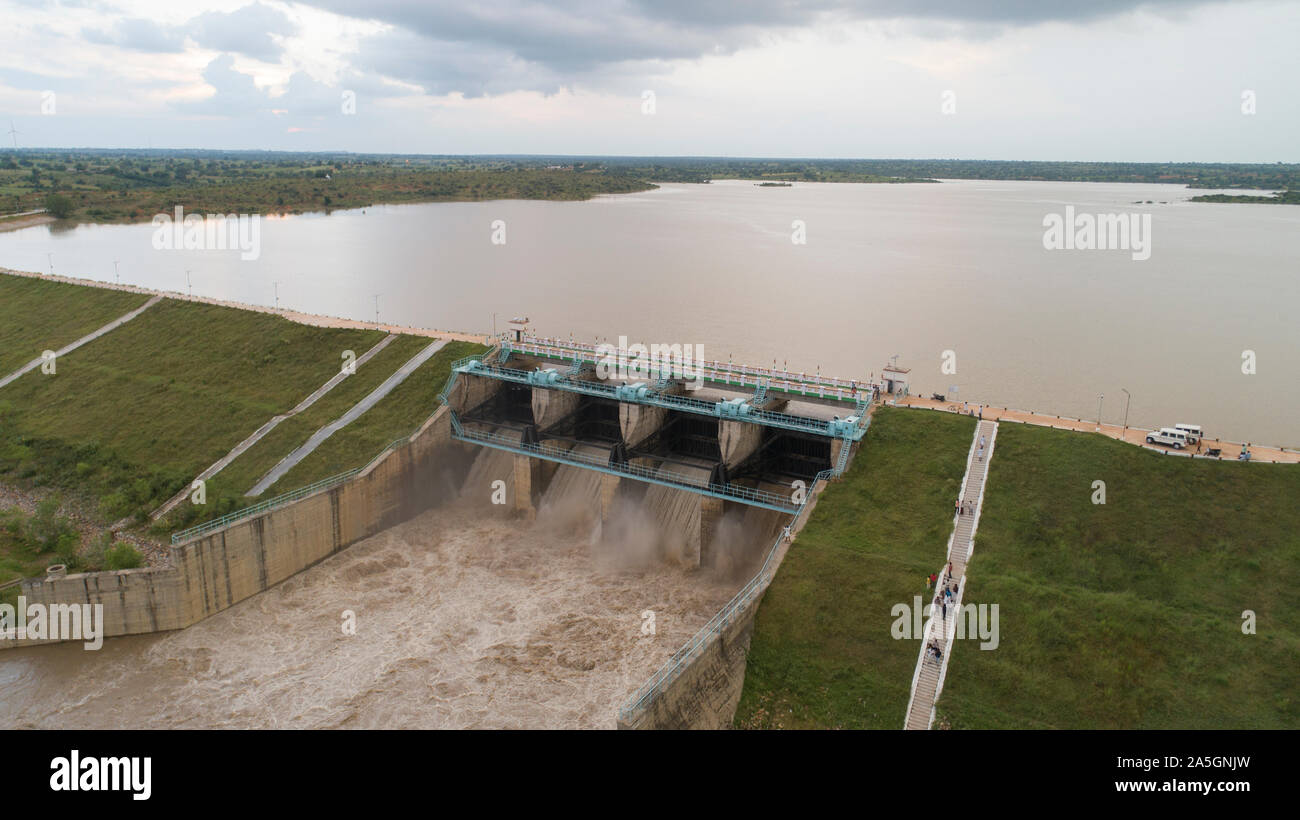 Aerial bird eye of water reservoir flood gates open to release water during monsoon flood from dam at raichur, India Stock Photo