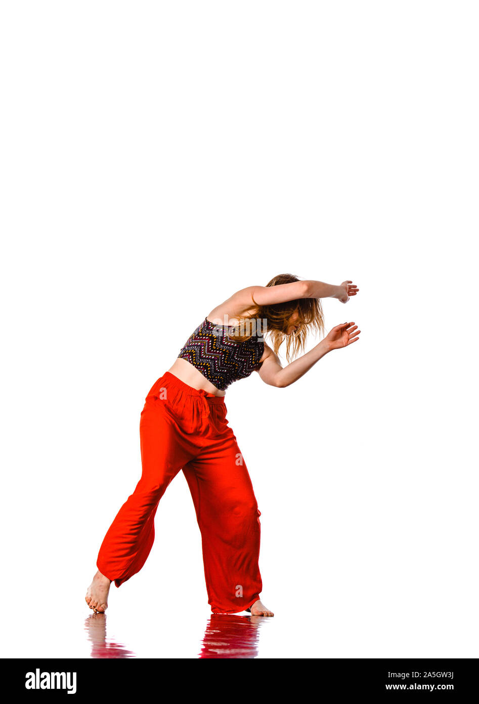 Aerobics woman. Portrait of pretty smiling girl training dance on studio background Stock Photo