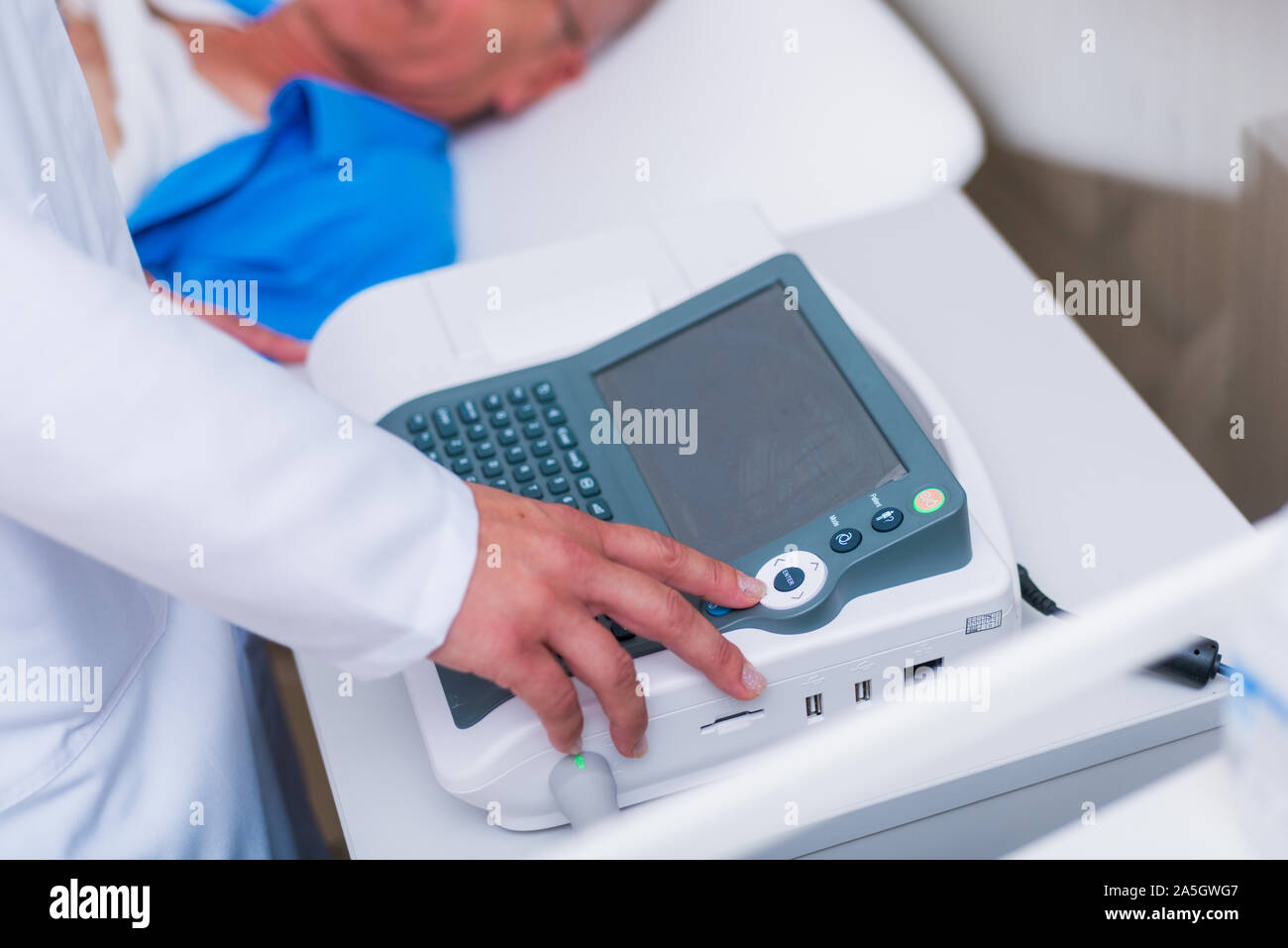 Doctor ( cardiologist ) is attaching vacuum sensors to an elder ...