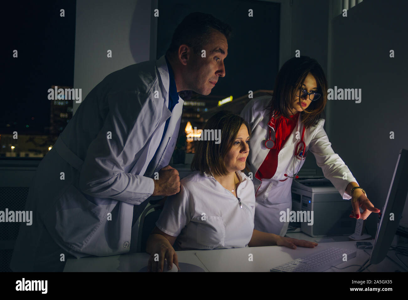 Doctors work at the office at night on a pc ( computer Stock Photo - Alamy