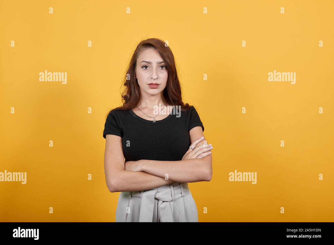 Rude girl standing and waiting to ask someone who made her unhappy ...