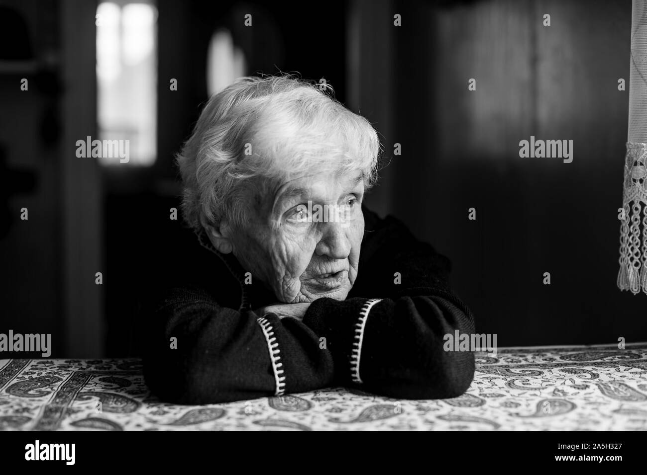 Lonely sad old woman. Black and white photo. Stock Photo