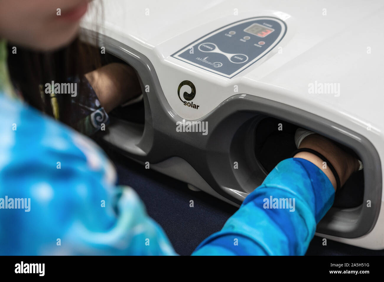 Woman process at cosmetology procedure with massage apparatus hand