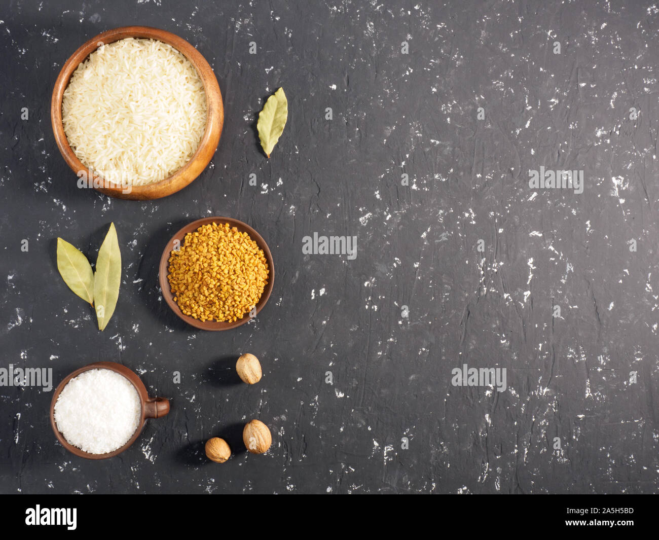 Rice and spices on a black concrete background. Indian cuisine ...