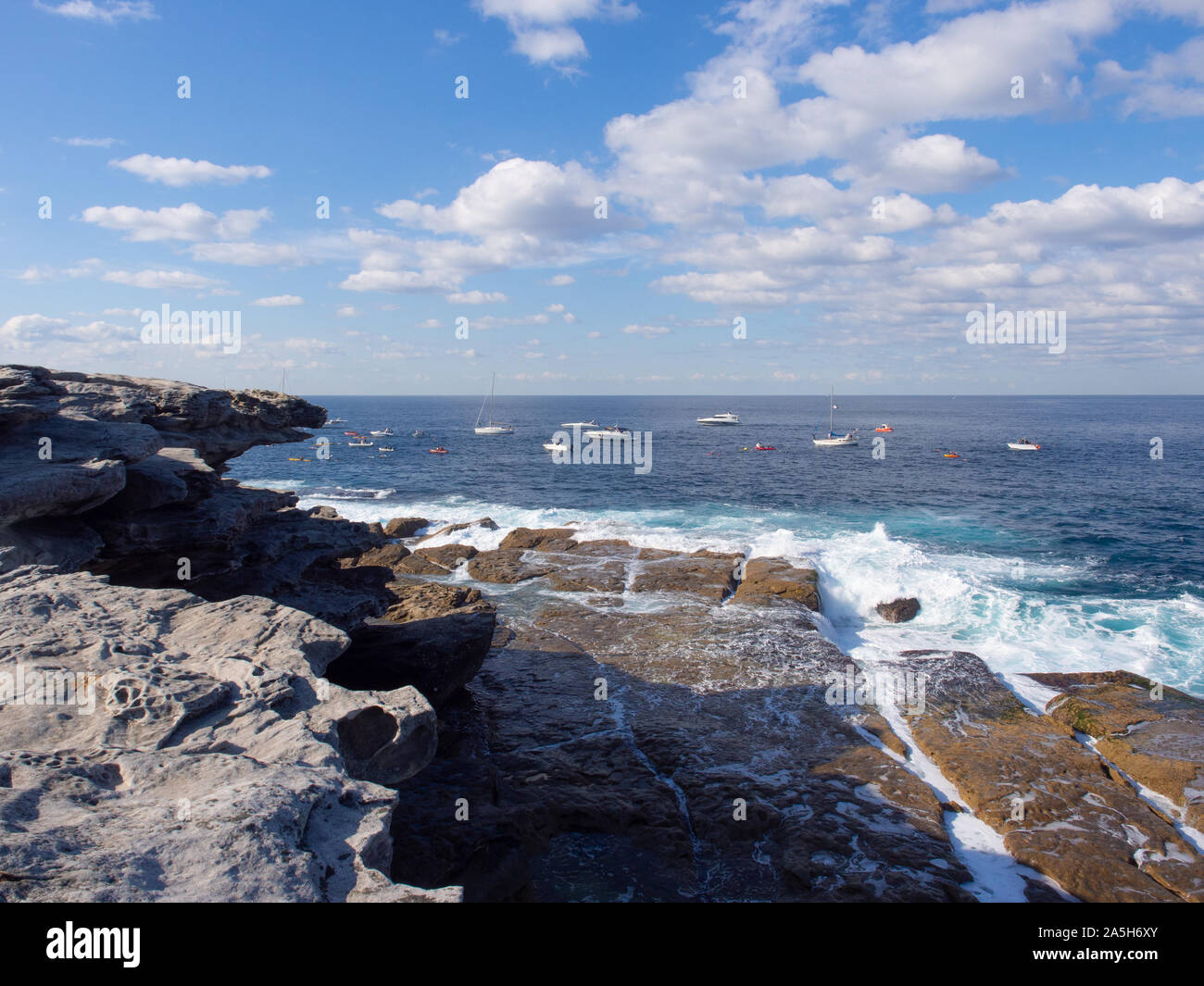 Boats Of The Rocky Bondi Coastline In Sydney Stock Photo