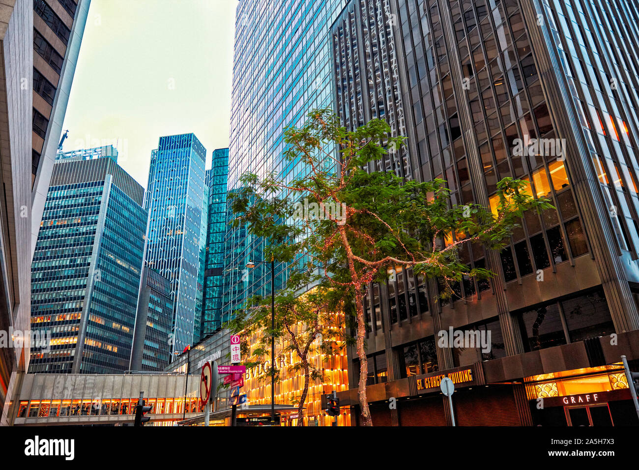 Modern high-rise buildings on Chater Road illuminated at dusk. Central, Hong Kong, China. Stock Photo