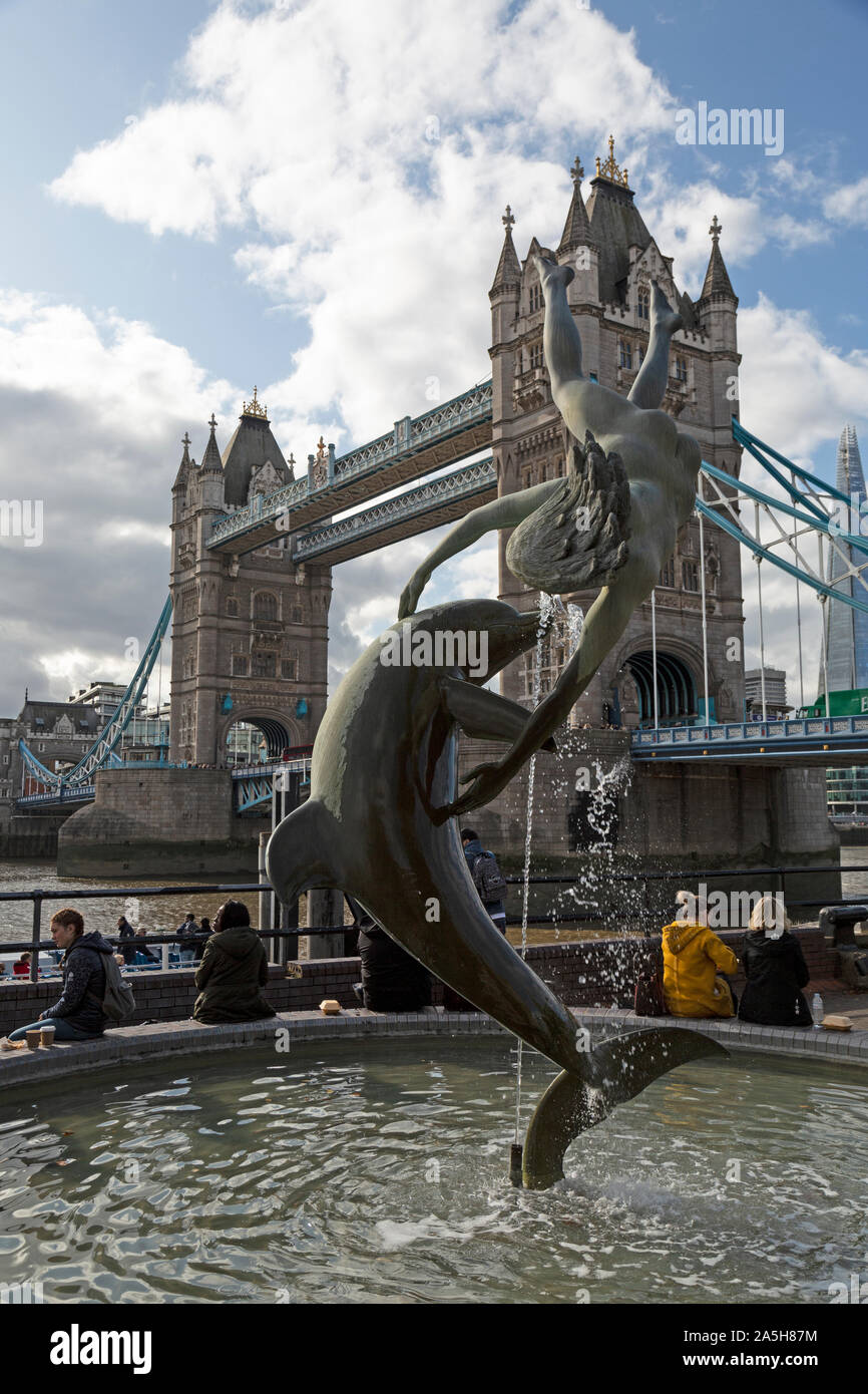 The Boy With A Dolphin Statue by the River Thames in London, england, with Tower Bridge in the background. Stock Photo